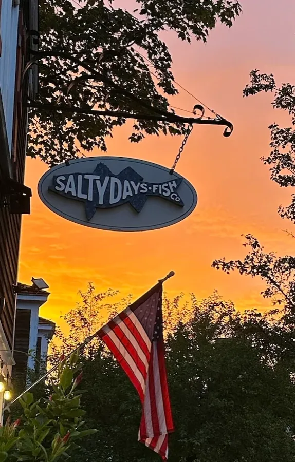 Salty Days Fish Co. sign at sunset in Cohasset